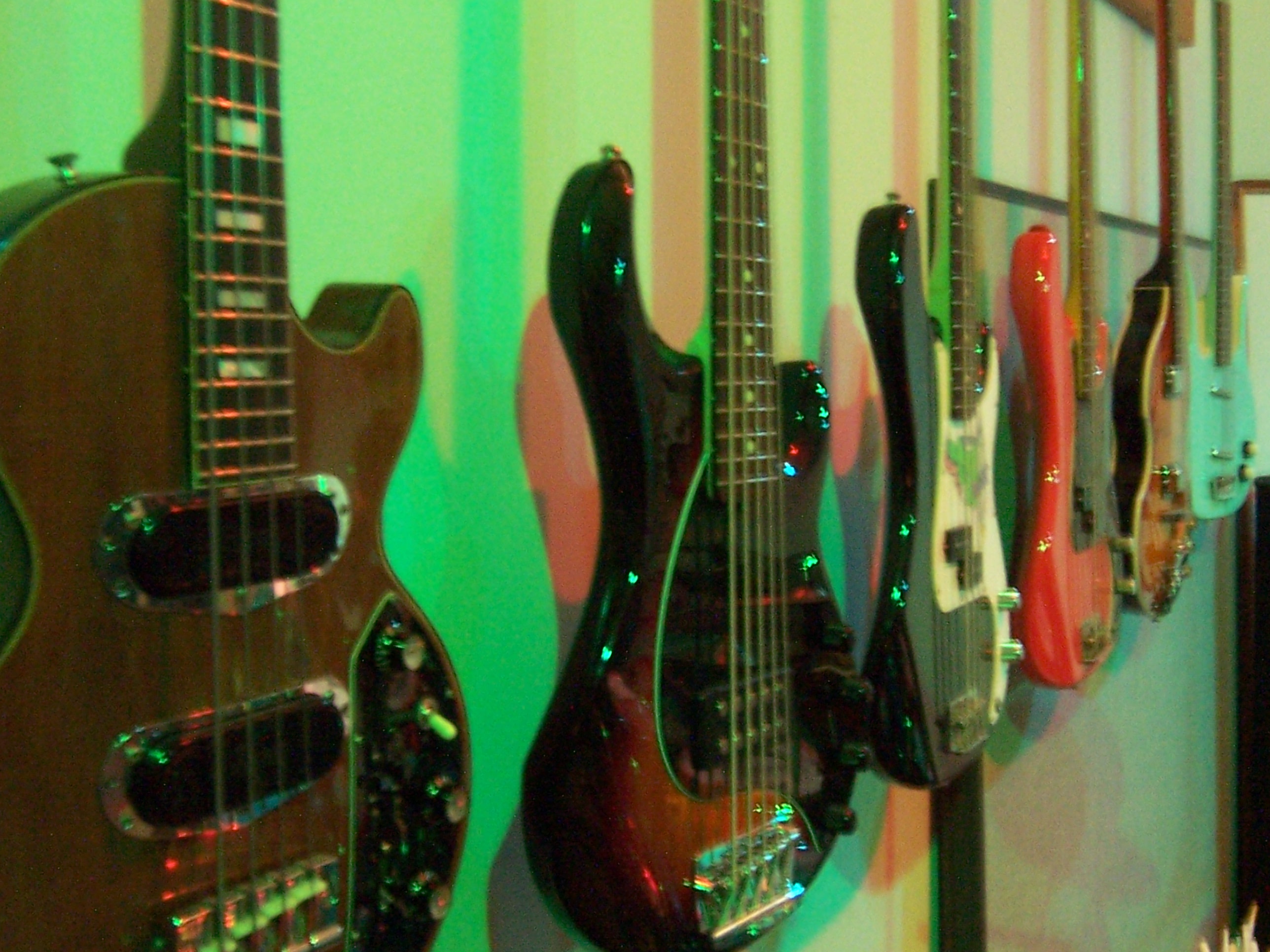 room full of guitars on wall and on couch