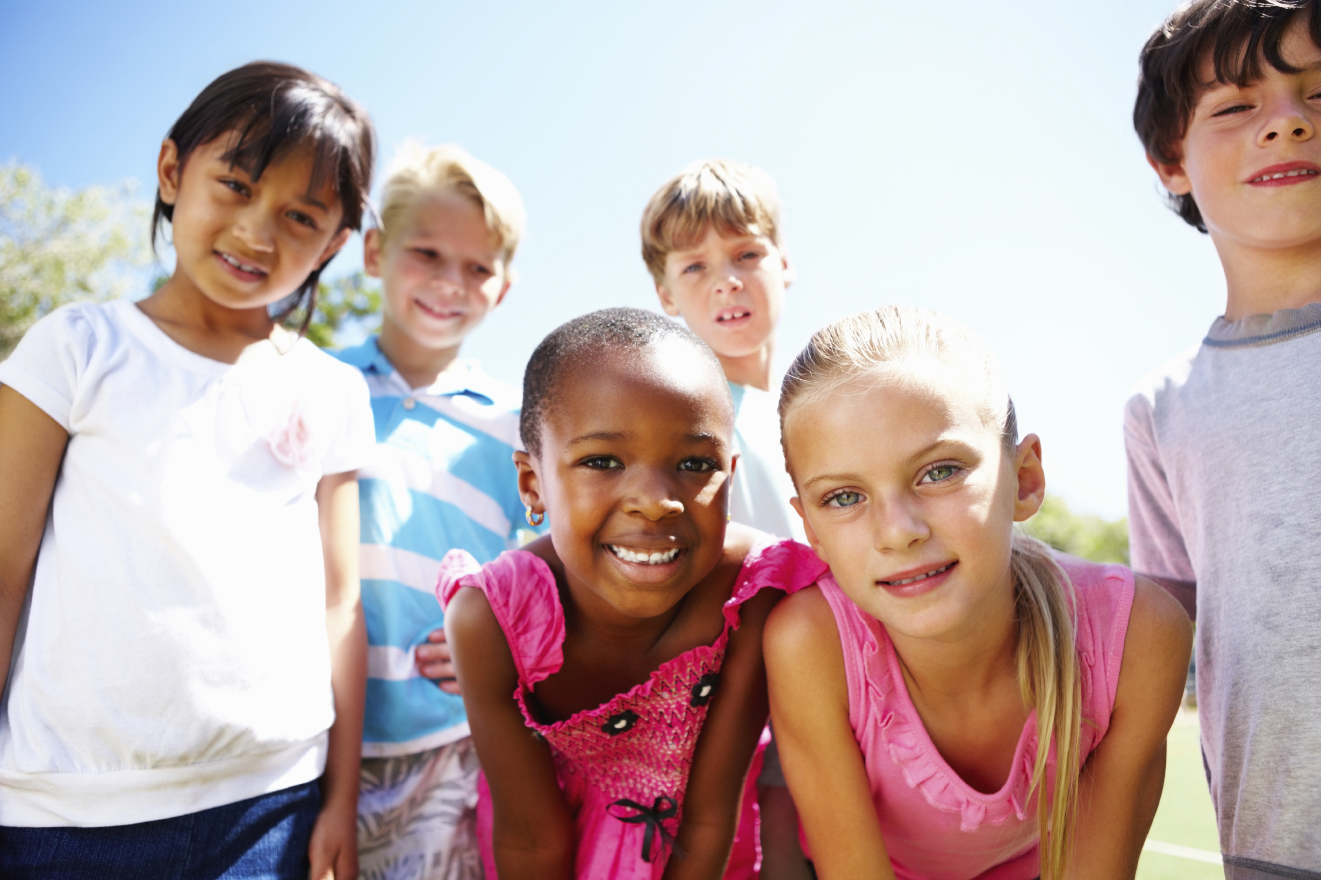 six children of different races and ages smiling