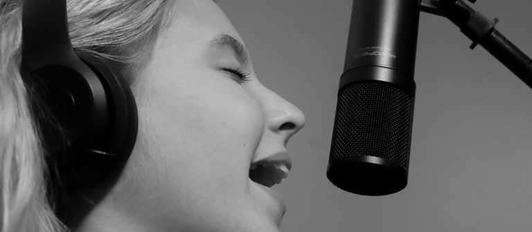 close up of girl singing into microphone